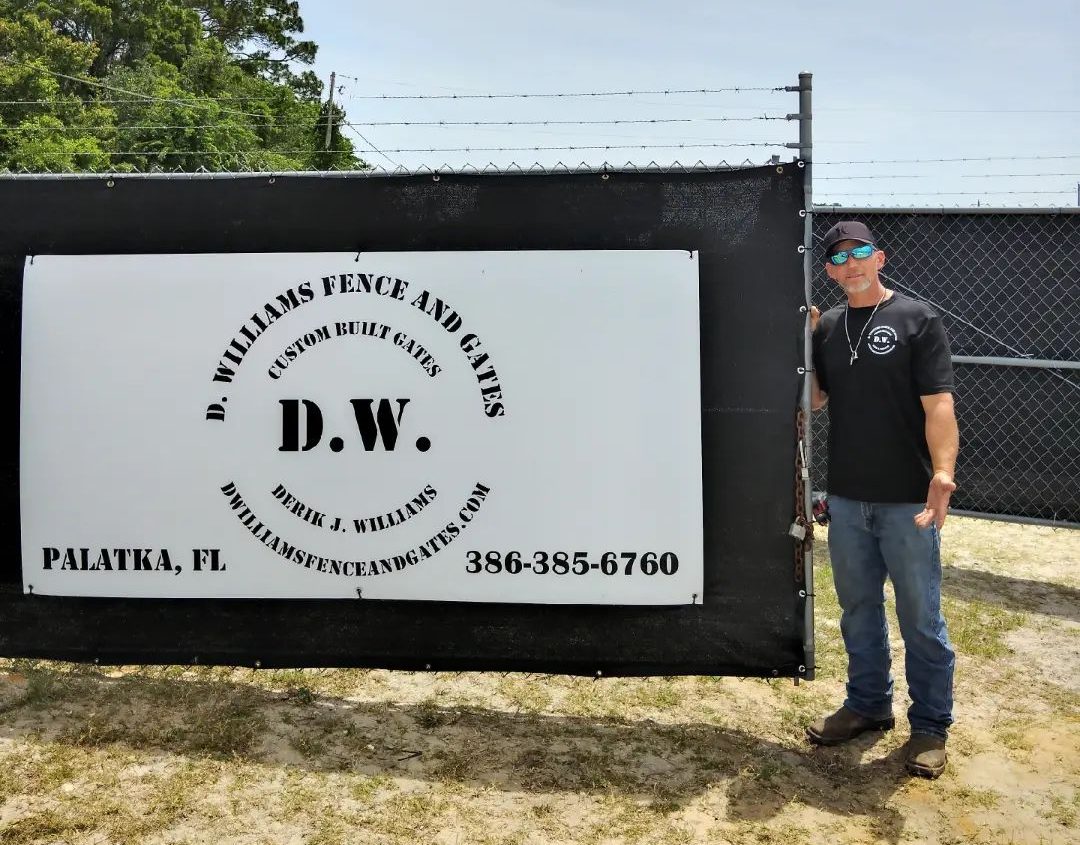 company owner standing next to billboard